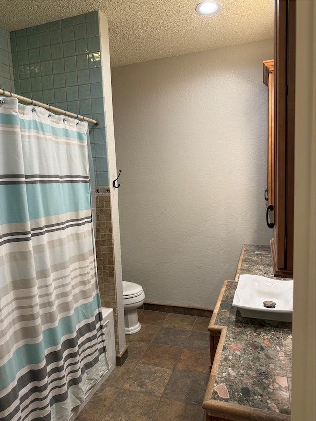 bathroom featuring toilet, a textured ceiling, vanity, and a shower with shower curtain