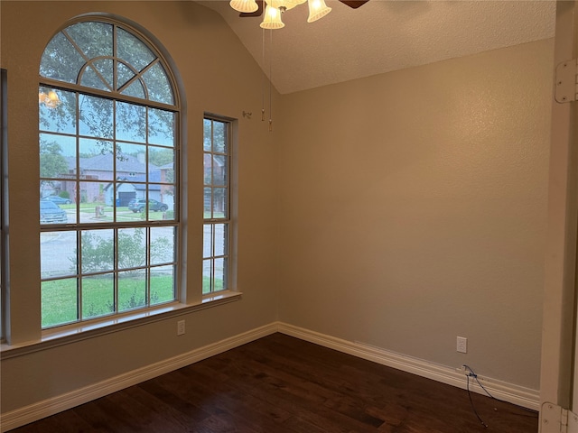 spare room featuring lofted ceiling, a textured ceiling, dark hardwood / wood-style floors, and ceiling fan