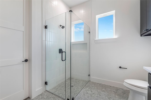 bathroom featuring vanity, toilet, and an enclosed shower