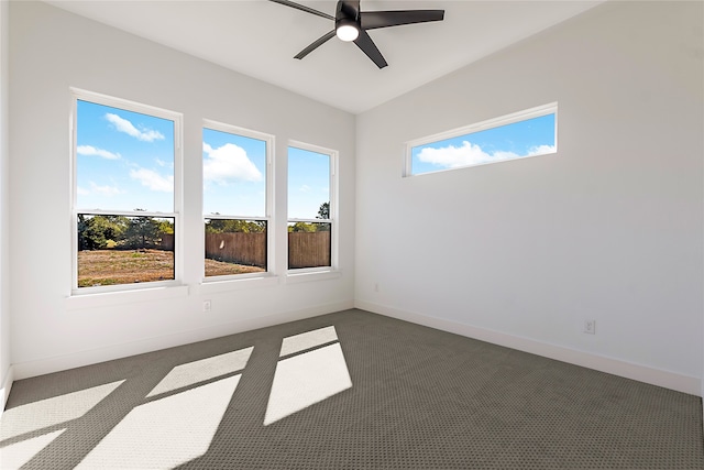 unfurnished room featuring dark colored carpet and a wealth of natural light