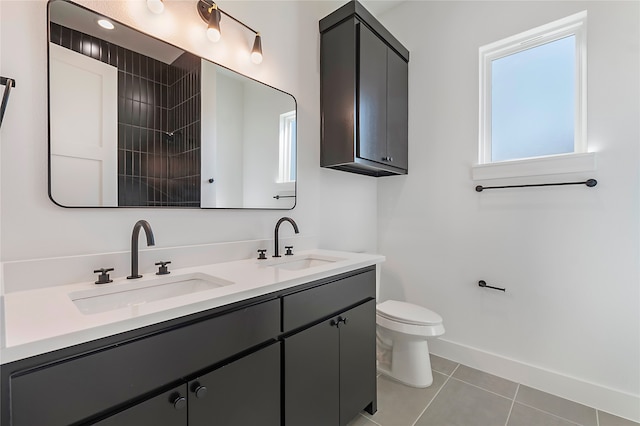 bathroom with a shower, vanity, toilet, and tile patterned floors