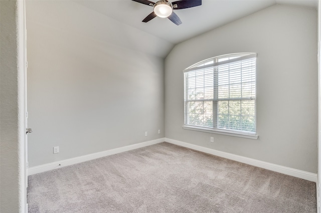 empty room with lofted ceiling, light carpet, and ceiling fan