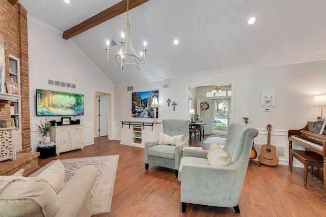 living room featuring light wood-type flooring, ornamental molding, beam ceiling, high vaulted ceiling, and an inviting chandelier