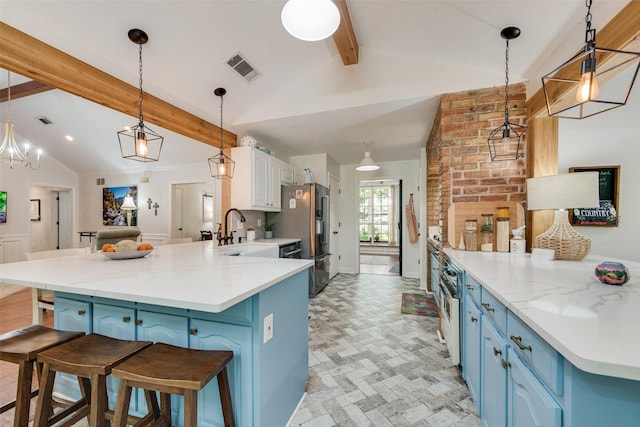 kitchen featuring pendant lighting, lofted ceiling with beams, blue cabinets, and kitchen peninsula