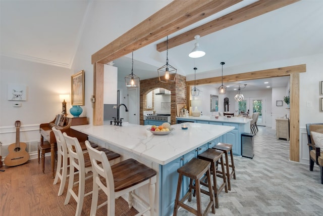 kitchen with a breakfast bar area, kitchen peninsula, hanging light fixtures, and beam ceiling