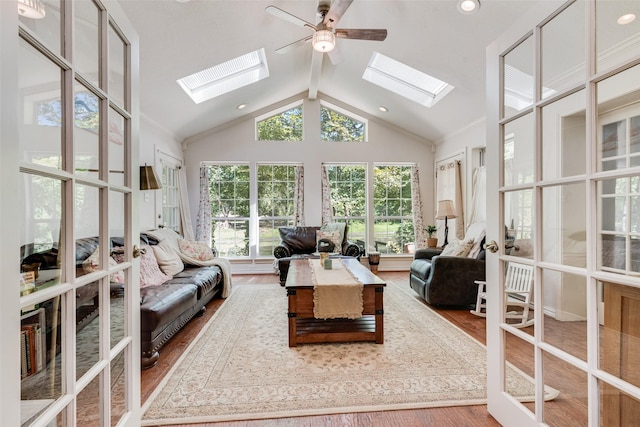 living room featuring hardwood / wood-style flooring, vaulted ceiling, and ceiling fan