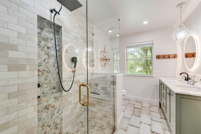 bathroom with vanity, toilet, and a shower with shower door