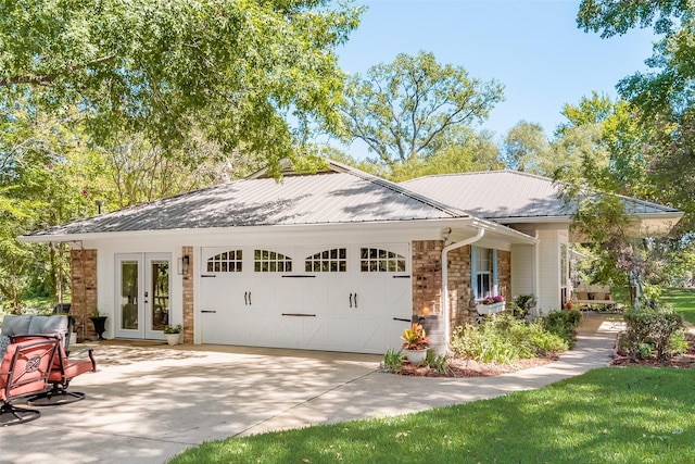 view of front of property featuring a garage and french doors