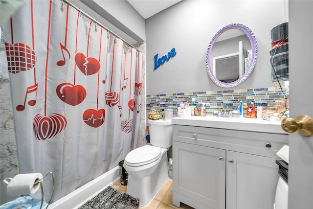 bathroom featuring tile walls, tile patterned flooring, toilet, vanity, and curtained shower