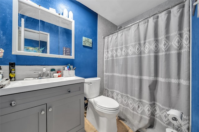 bathroom with curtained shower, tile patterned flooring, vanity, and toilet