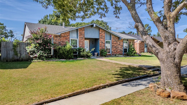 ranch-style home with a front lawn