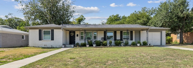 ranch-style house featuring a garage, a porch, and a front yard