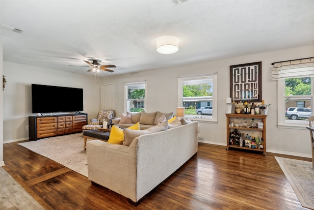 living room with dark hardwood / wood-style floors and ceiling fan