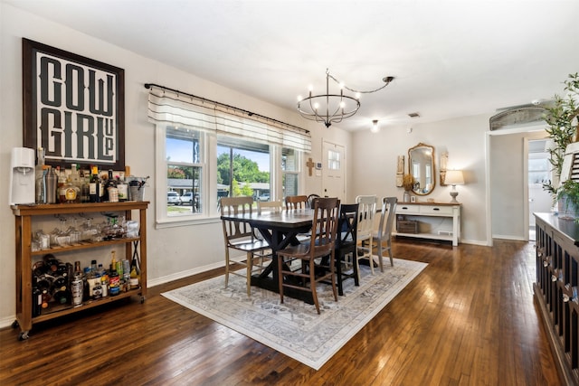 dining space with dark hardwood / wood-style floors and a chandelier