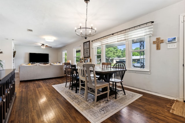 dining space featuring dark hardwood / wood-style floors and ceiling fan with notable chandelier