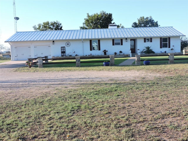 view of front facade with a front lawn and a garage