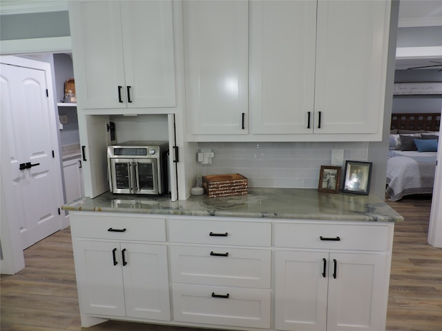 kitchen featuring light wood-type flooring and white cabinetry