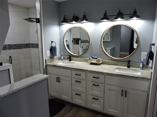 bathroom with walk in shower, hardwood / wood-style floors, and vanity