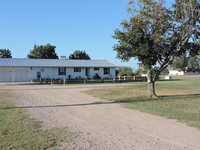 view of front of property with a garage and a front lawn