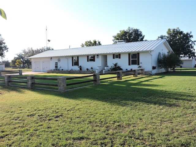 ranch-style home with a front yard and a garage