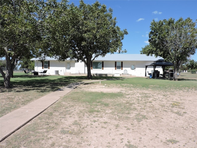 view of front facade featuring a gazebo and a front lawn