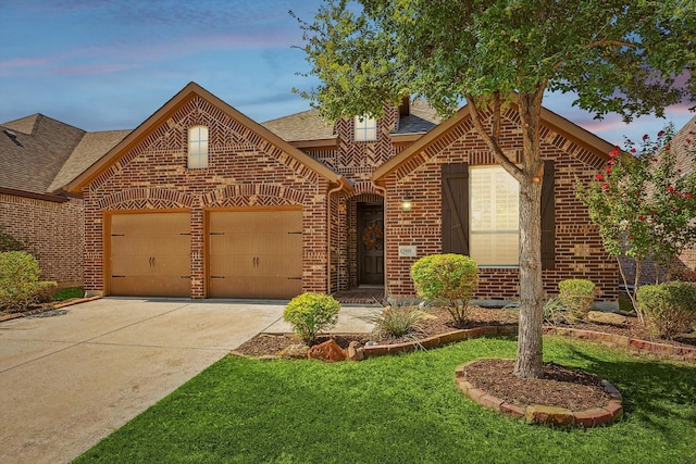 view of front of house with a lawn and a garage