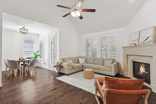 living room featuring high vaulted ceiling, ceiling fan, dark hardwood / wood-style flooring, and a wealth of natural light