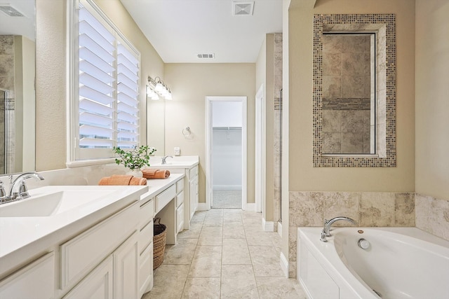 bathroom featuring separate shower and tub, tile patterned flooring, and vanity