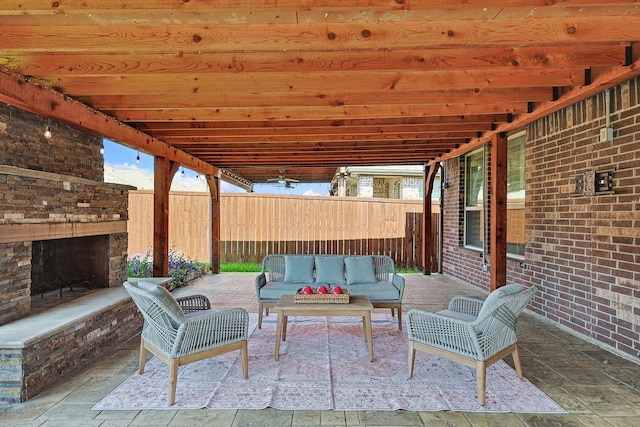 view of patio with an outdoor living space with a fireplace