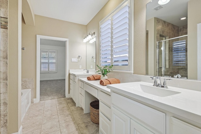 bathroom with tile patterned flooring, shower with separate bathtub, and vanity