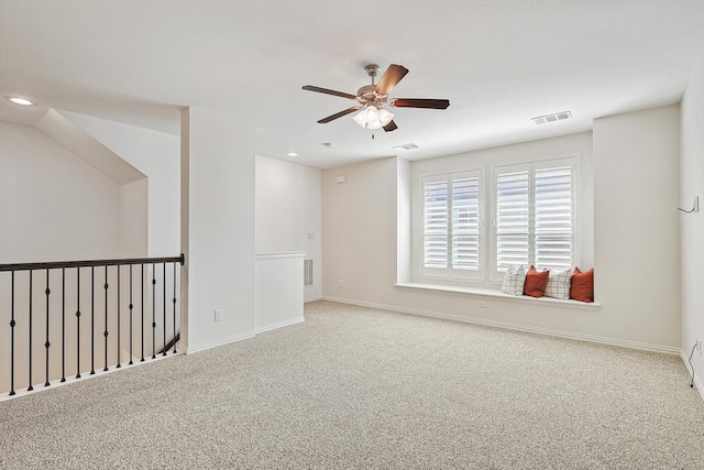 carpeted empty room featuring ceiling fan