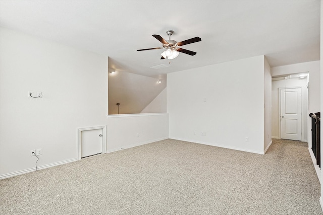 empty room with light colored carpet, vaulted ceiling, and ceiling fan