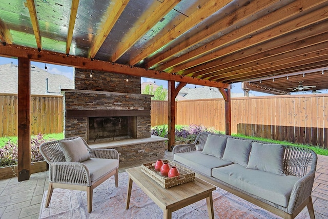 view of patio with an outdoor living space with a fireplace