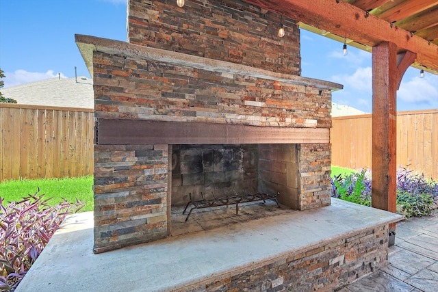 exterior details with an outdoor fireplace