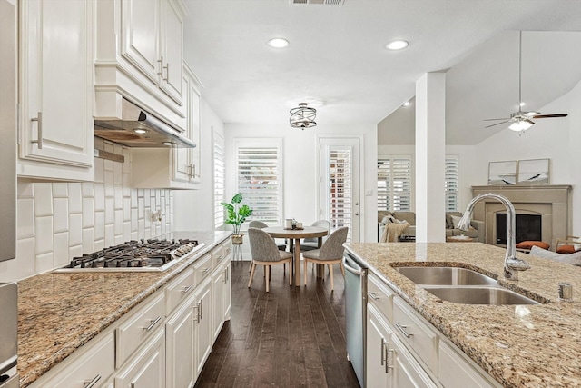 kitchen featuring stainless steel appliances, white cabinetry, a healthy amount of sunlight, and sink