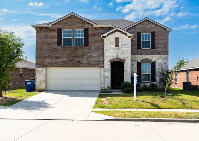 view of front of property with a garage and a front lawn