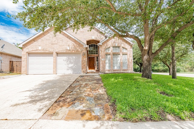 view of front facade featuring a front yard and a garage