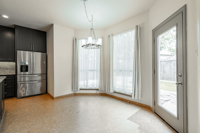 kitchen featuring an inviting chandelier, stainless steel refrigerator with ice dispenser, and decorative light fixtures