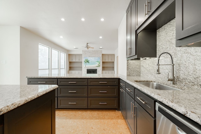 kitchen featuring backsplash, light stone counters, ceiling fan, and stainless steel dishwasher