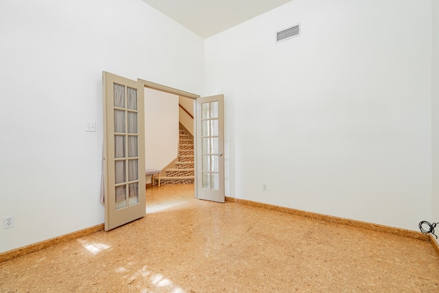 300 Turtle Ct, Mckinney, TX 75072 - empty room featuring french doors, baseboards, a towering ceiling, visible vents, and stairway