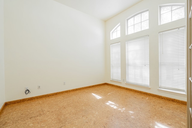 unfurnished room with a wealth of natural light and carpet floors