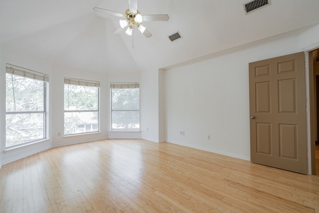 empty room featuring high vaulted ceiling, ceiling fan, and light hardwood / wood-style flooring