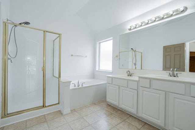 bathroom with lofted ceiling, vanity, and separate shower and tub