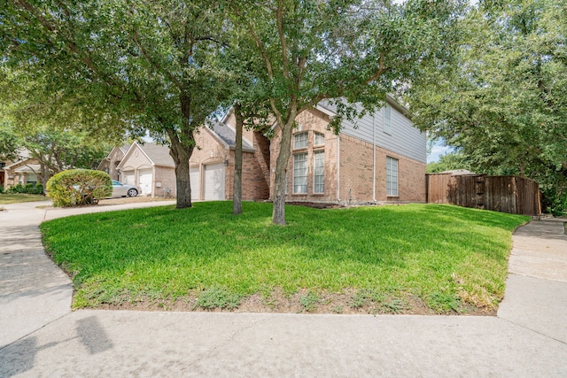 view of front of property with a front lawn and a garage