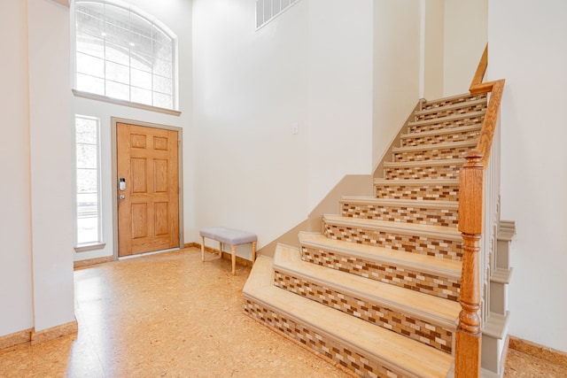 300 Turtle Ct, Mckinney, TX 75072 - entryway with baseboards, a high ceiling, stairs, and visible vents