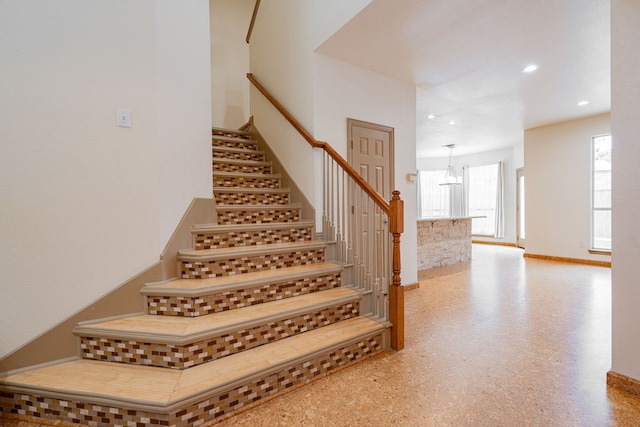 stairway with an inviting chandelier