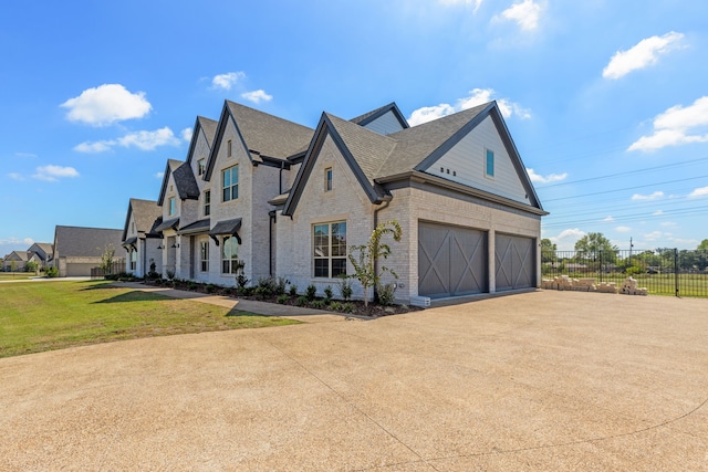 view of side of property with a yard and a garage