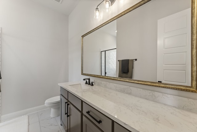 bathroom featuring vanity and toilet