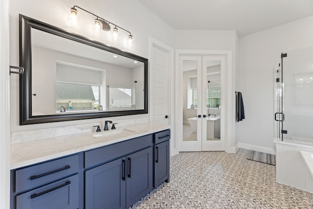 bathroom featuring independent shower and bath, vanity, and french doors