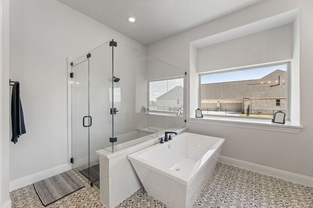 bathroom featuring plus walk in shower and tile patterned floors